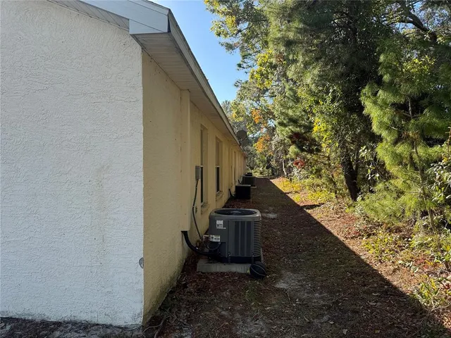 a view of a pathway of a house with wooden fence