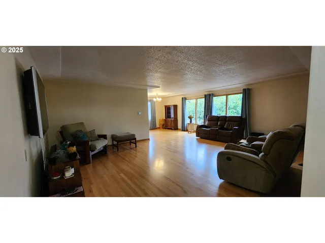 a view of hallway with furniture and a chandelier