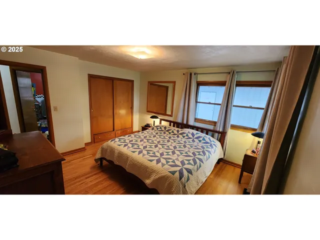 a bedroom with a bed and a night stand