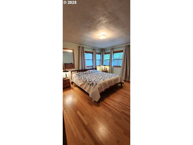 a bedroom with furniture and a flat screen tv