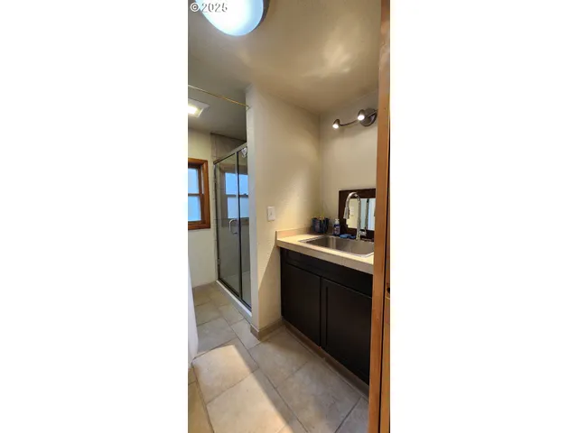 a large bathroom with a sink and a mirror