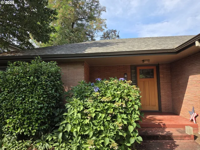 a front view of a house with garden