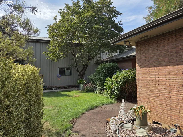 a kitchen with stainless steel appliances granite countertop a sink dishwasher stove and refrigerator with wooden floor