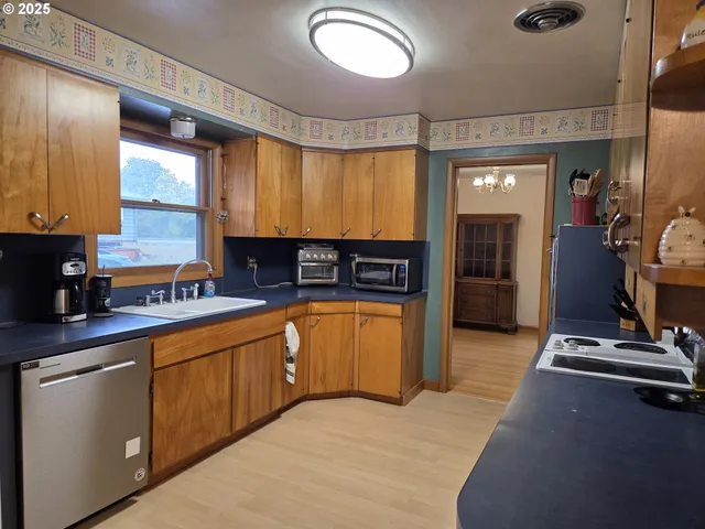 a kitchen with stainless steel appliances granite countertop a refrigerator and a sink
