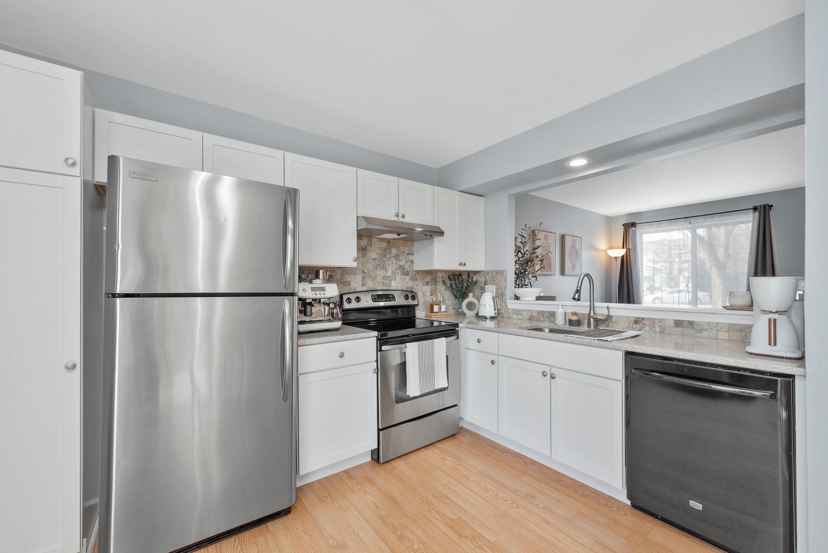 2655 Prairieview Lane South Aurora, IL 60502 - Photo 5 of 13 a kitchen with white cabinets stainless steel appliances and a sink