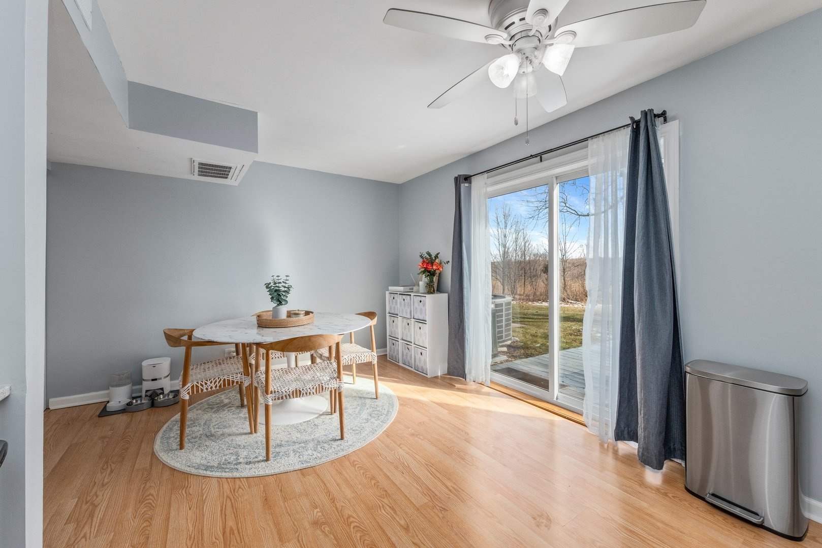 2655 Prairieview Lane South Aurora, IL 60502 - Photo 7 of 13 a dining room with wooden floor a chandelier fan a wooden table and chairs