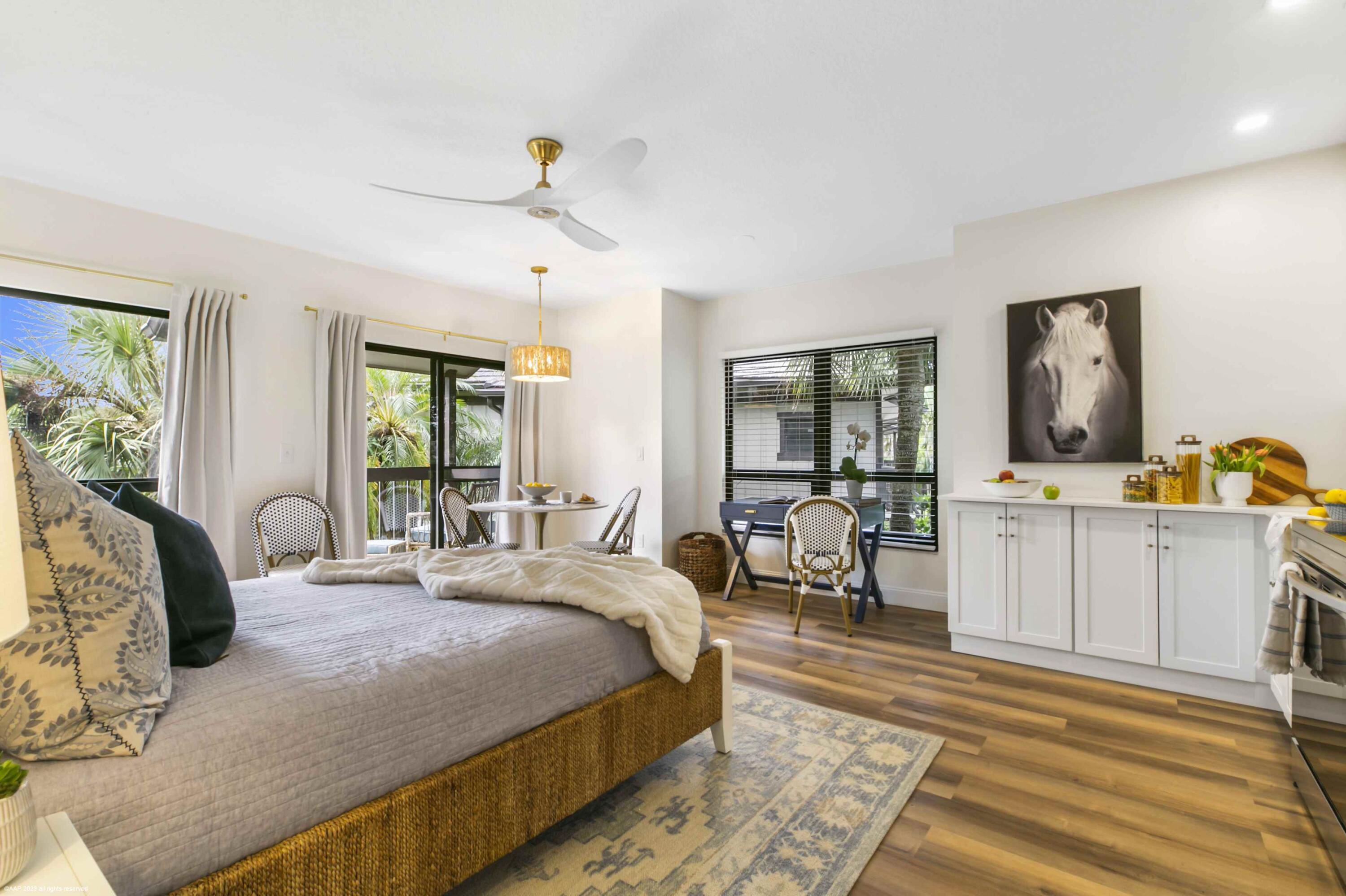 13334 Polo Club Road, Unit 347 Wellington, FL 33414 - Photo 3 of 15 a bedroom with a bed and large windows