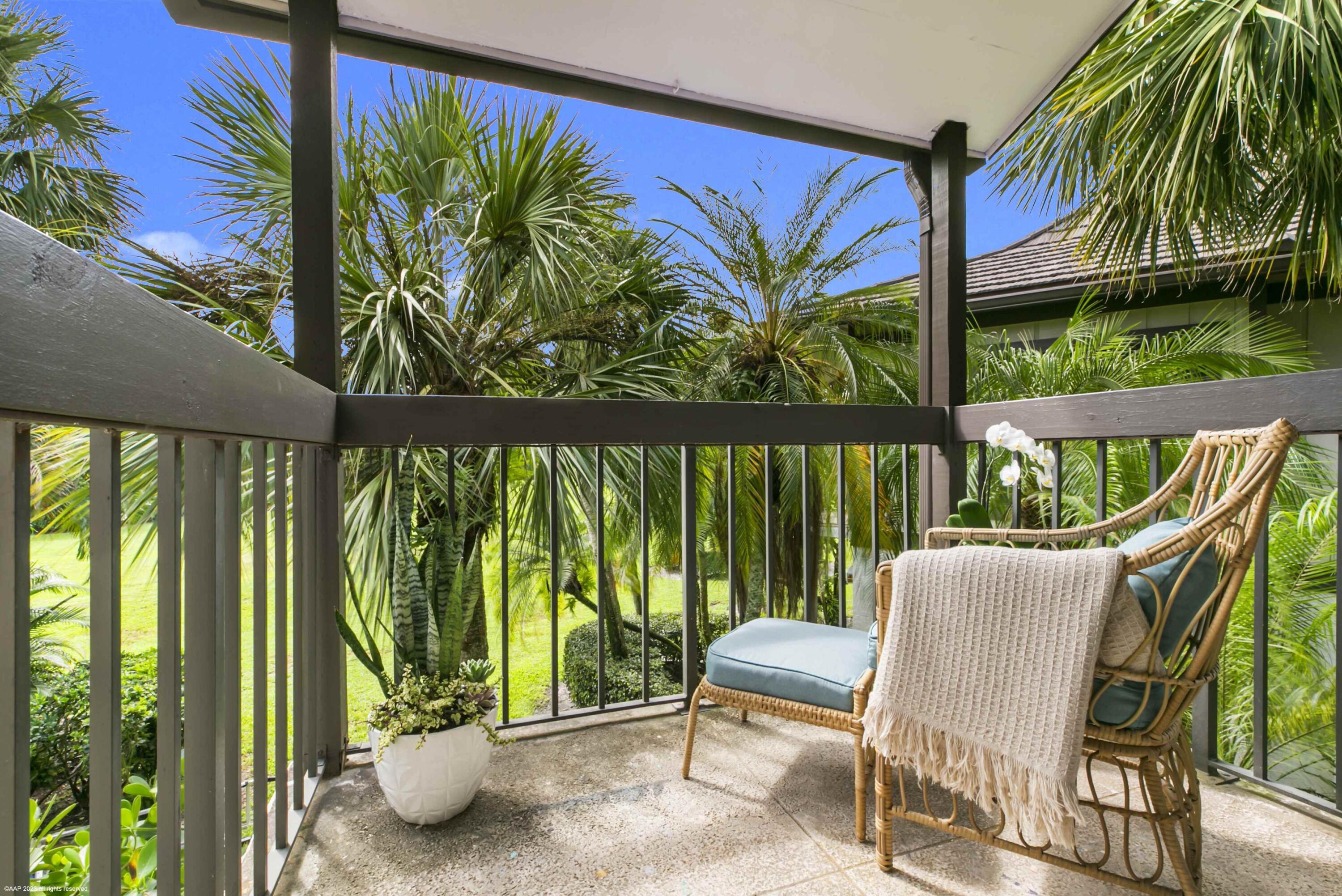 13334 Polo Club Road, Unit 347 Wellington, FL 33414 - Photo 8 of 15 a view of a chairs and table in patio next to a yard