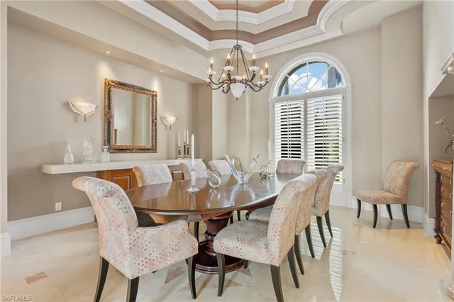 a view of a dining room with furniture and a chandelier