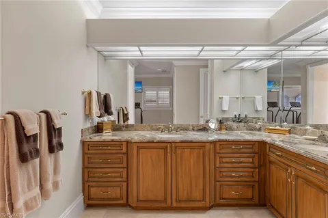 a bathroom with a granite countertop sink a vanity and a large mirror