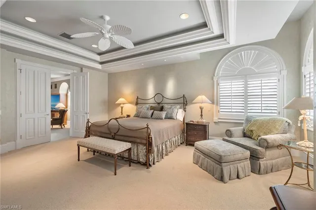 a spacious bedroom with two beds and a chandelier
