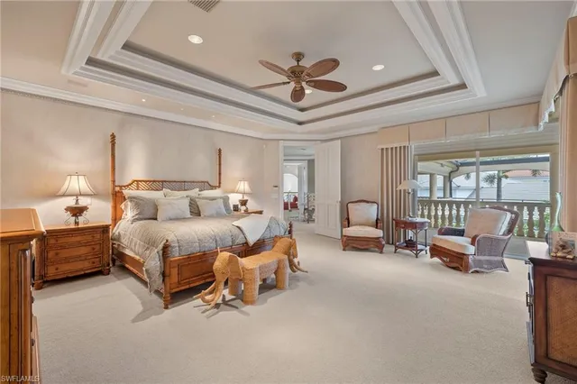 a spacious bedroom with a bed and a chandelier