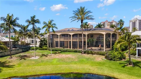 an aerial view of residential houses with outdoor space and lake view