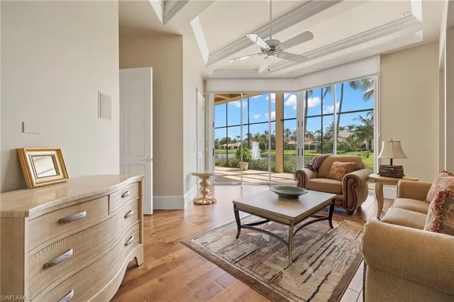 a living room with furniture and a floor to ceiling window
