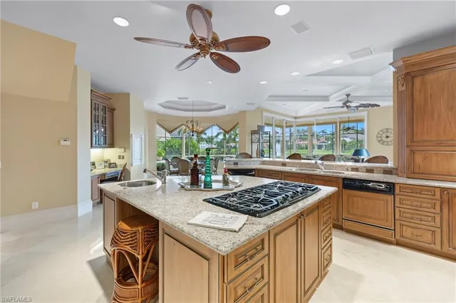 a kitchen with a stove a sink a kitchen island with wooden cabinets and floor