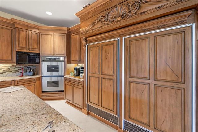 a kitchen with stainless steel appliances granite countertop a refrigerator oven a sink and dishwasher