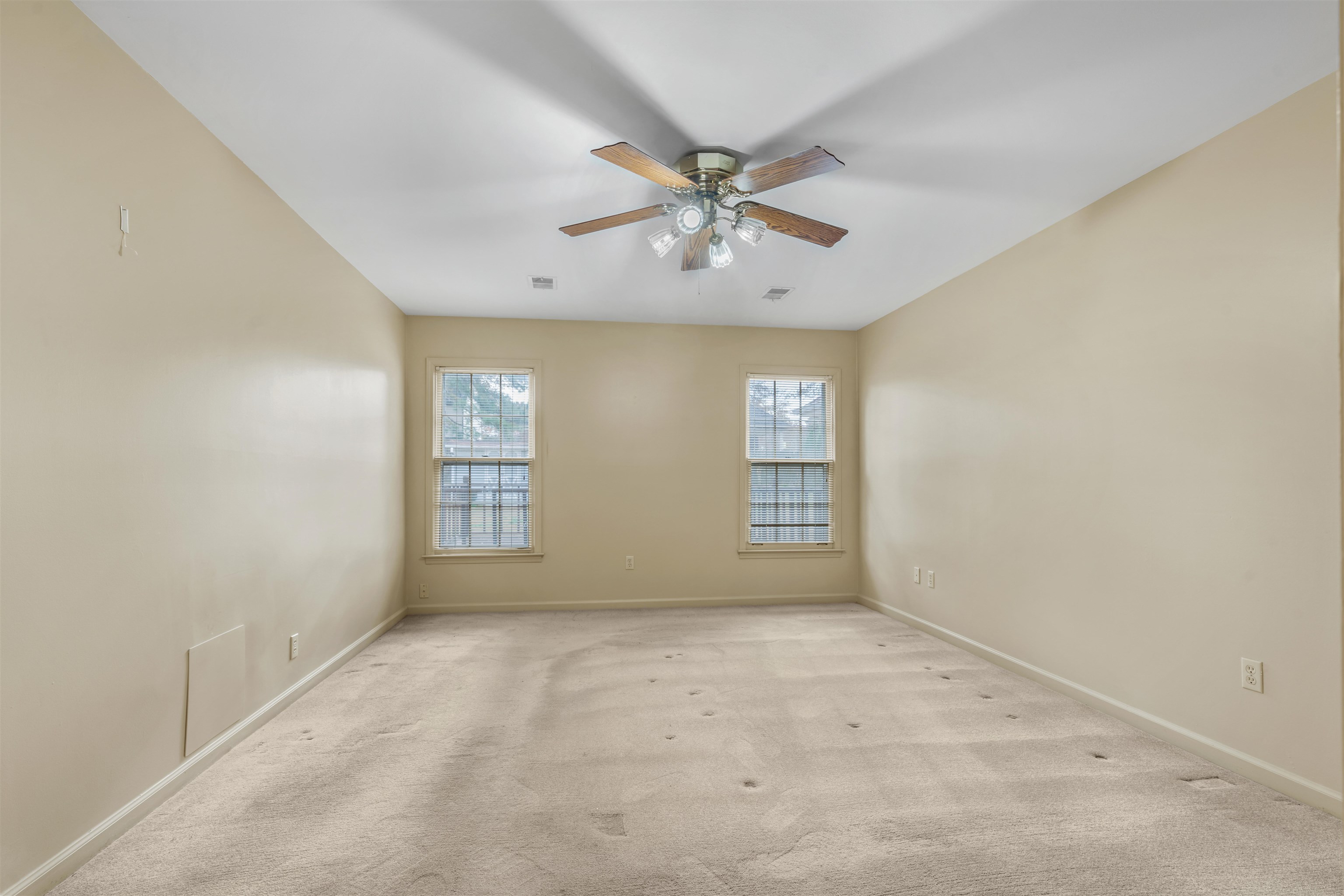 7087 Cutter Mill Road Memphis, TN 38141 - Photo 13 of 20 Spacious primary bedroom freshly painted with smooth ceiling, ceiling fan & neutral carpet.