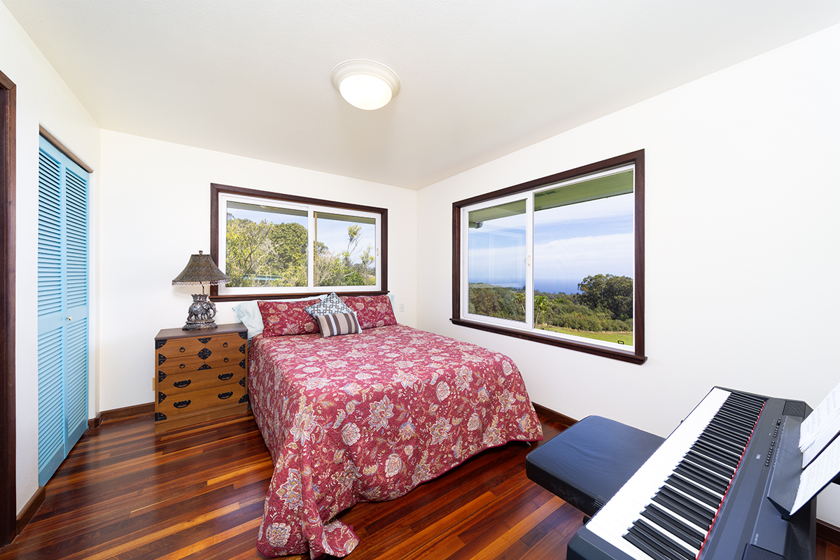 35-486 Pahale Road Papaaloa, HI 96780 - Photo 14 of 30 a bedroom with a bed and wooden floor