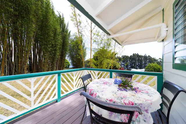 a large bedroom with a bed and wooden floor