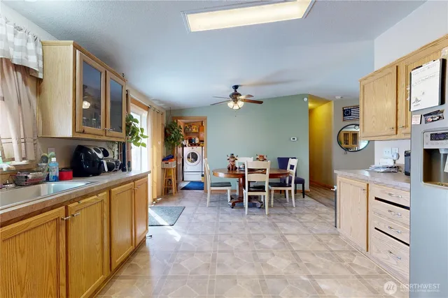 a kitchen with cabinets and chairs