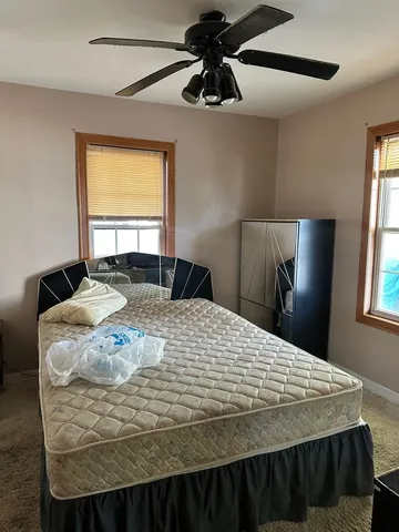 a bedroom with a bed and window