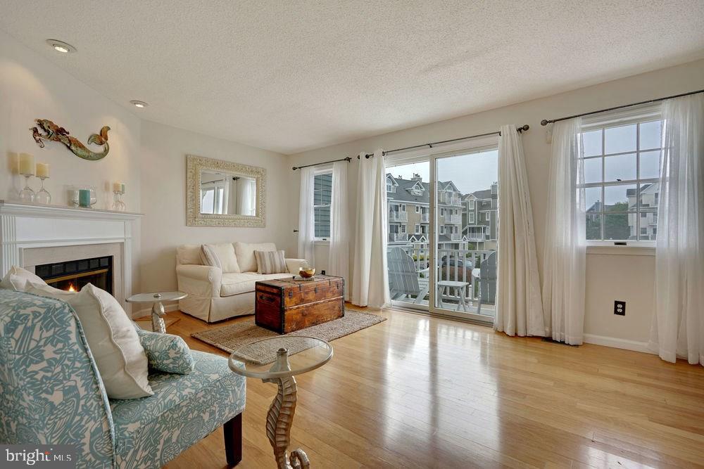 358 Captains Walk, Unit 58 Forked River, NJ 08731 - Photo 19 of 43 a living room with furniture large window and wooden floor