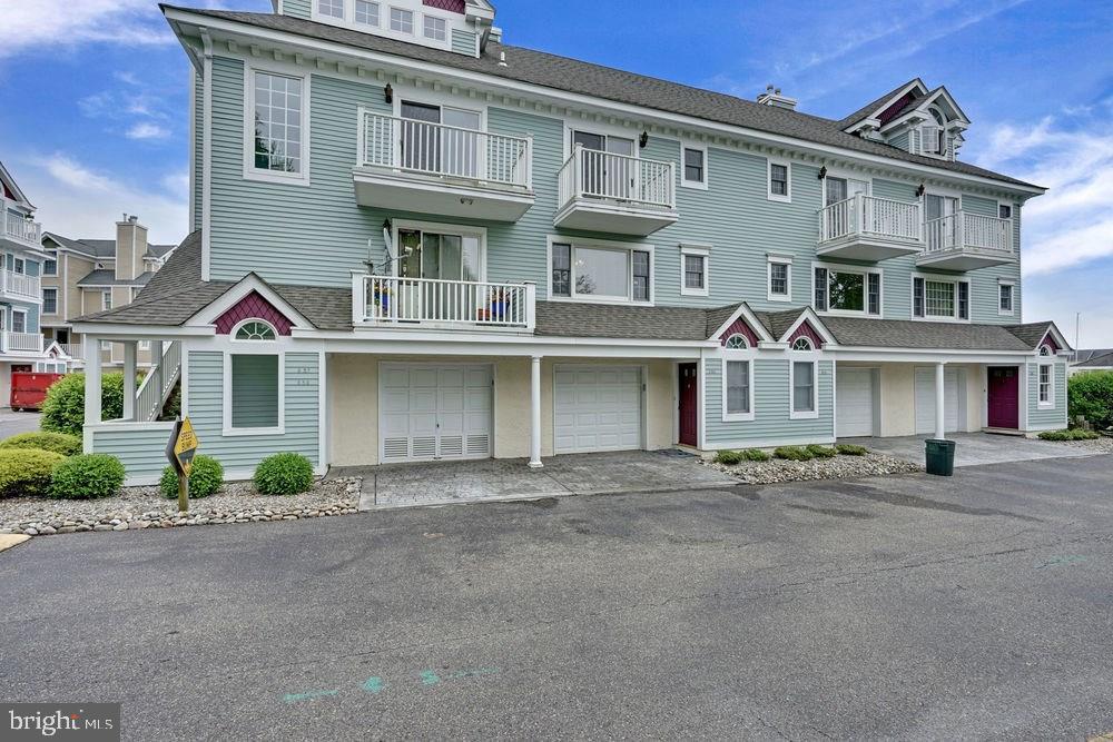 358 Captains Walk, Unit 58 Forked River, NJ 08731 - Photo 4 of 43 a front view of a house with a yard
