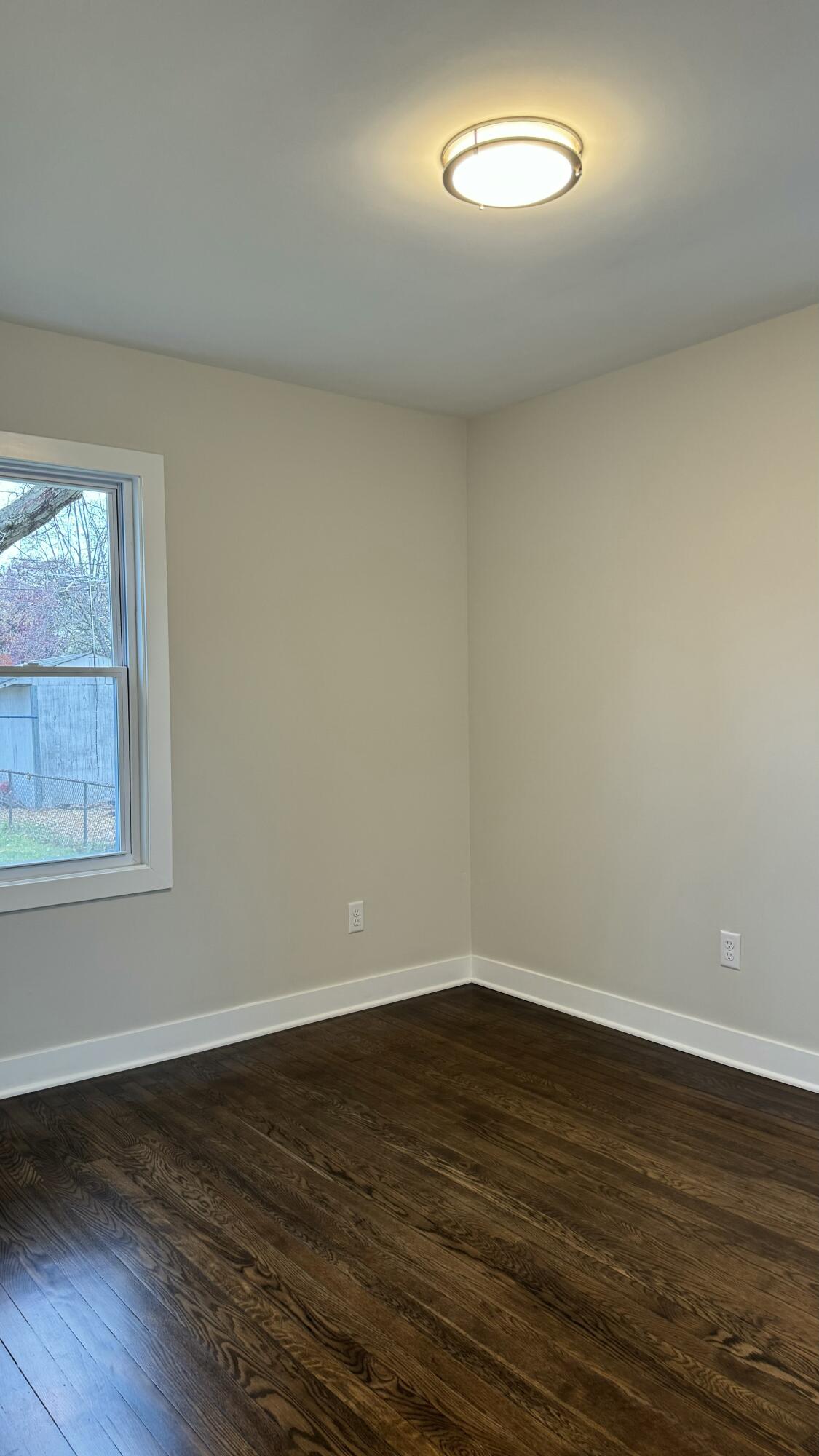 2926 State Street Lake Station, IN 46405 - Photo 14 of 16 a view of an empty room with wooden floor and a window