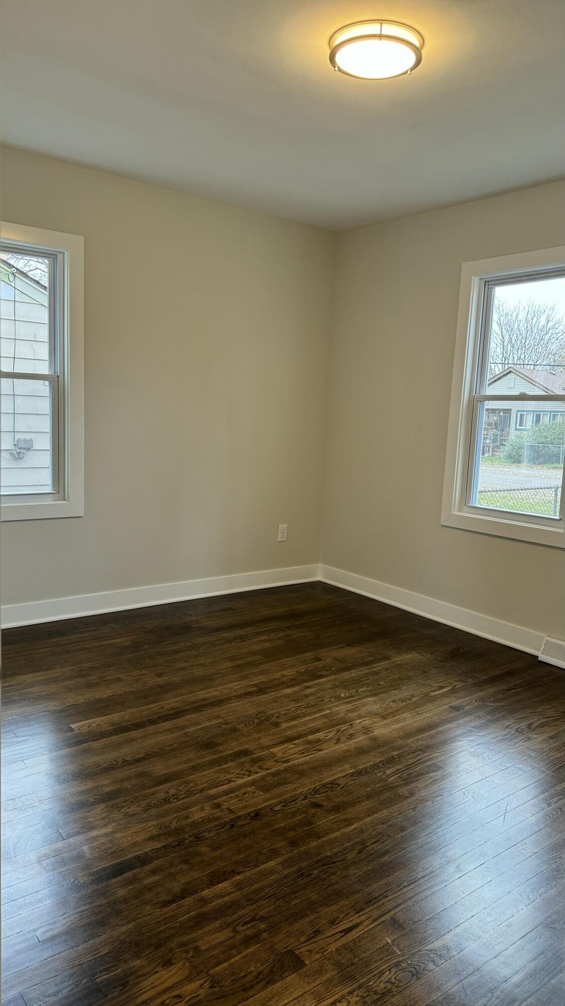 2926 State Street Lake Station, IN 46405 - Photo 15 of 16 an empty room with wooden floor and windows