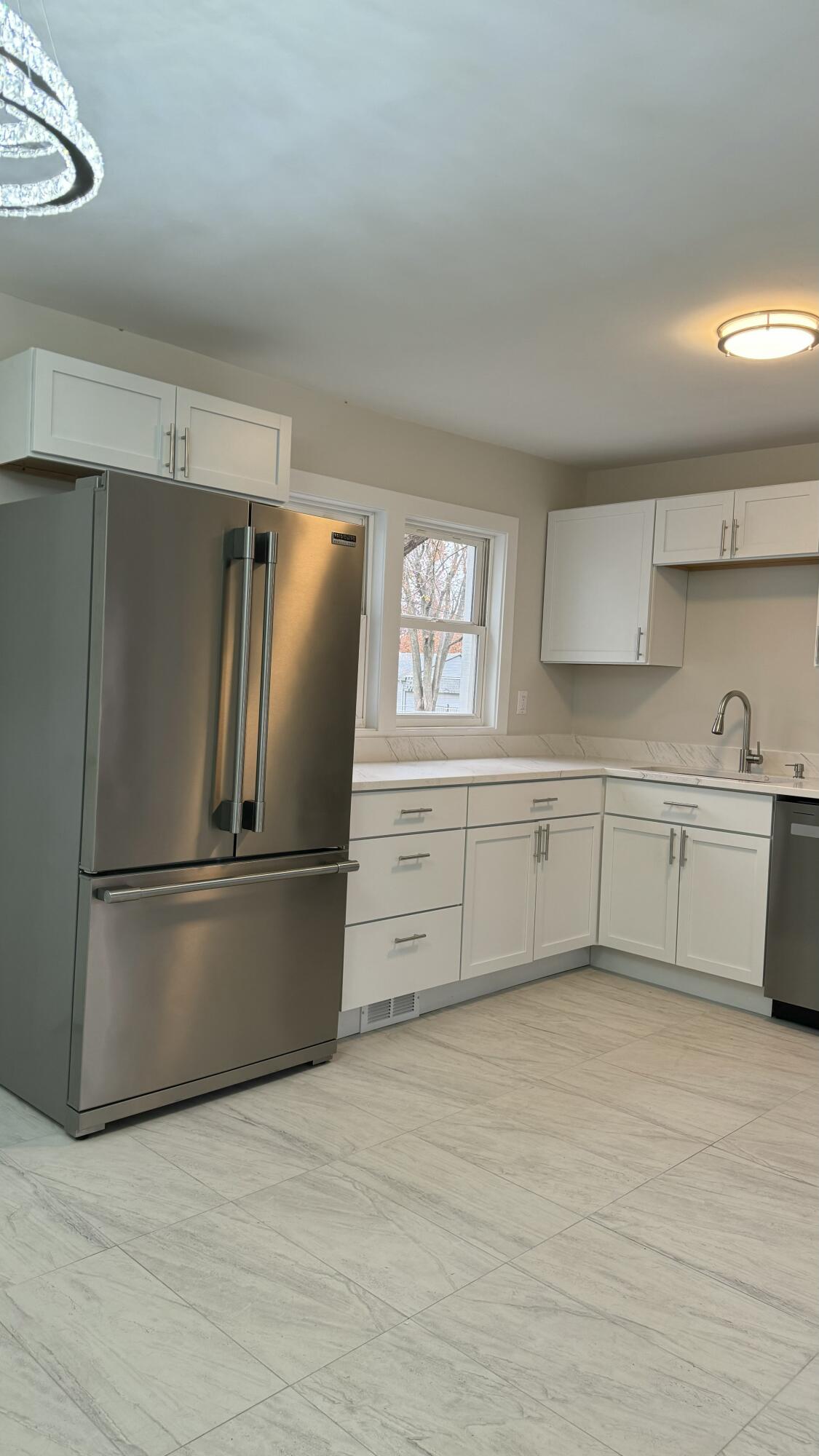 2926 State Street Lake Station, IN 46405 - Photo 9 of 16 a kitchen with stainless steel appliances a refrigerator sink and cabinets