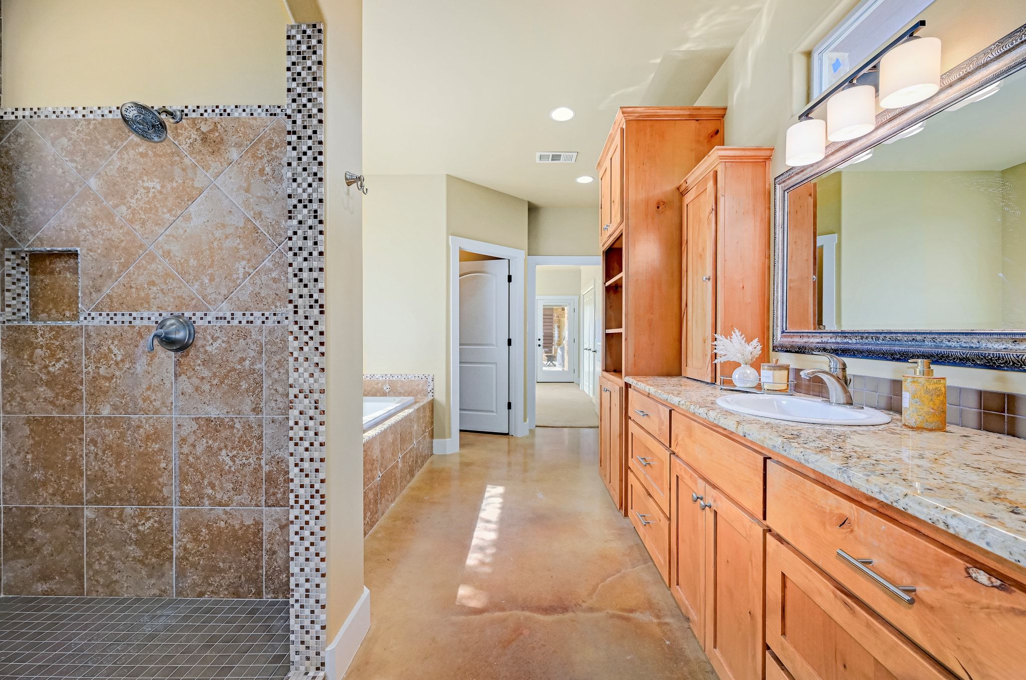 2551 Wolf Creek Ranch Road Burnet, TX 78611 - Photo 16 of 40 Full bathroom featuring vanity, a garden tub, a tile shower, recessed lighting, and concrete flooring