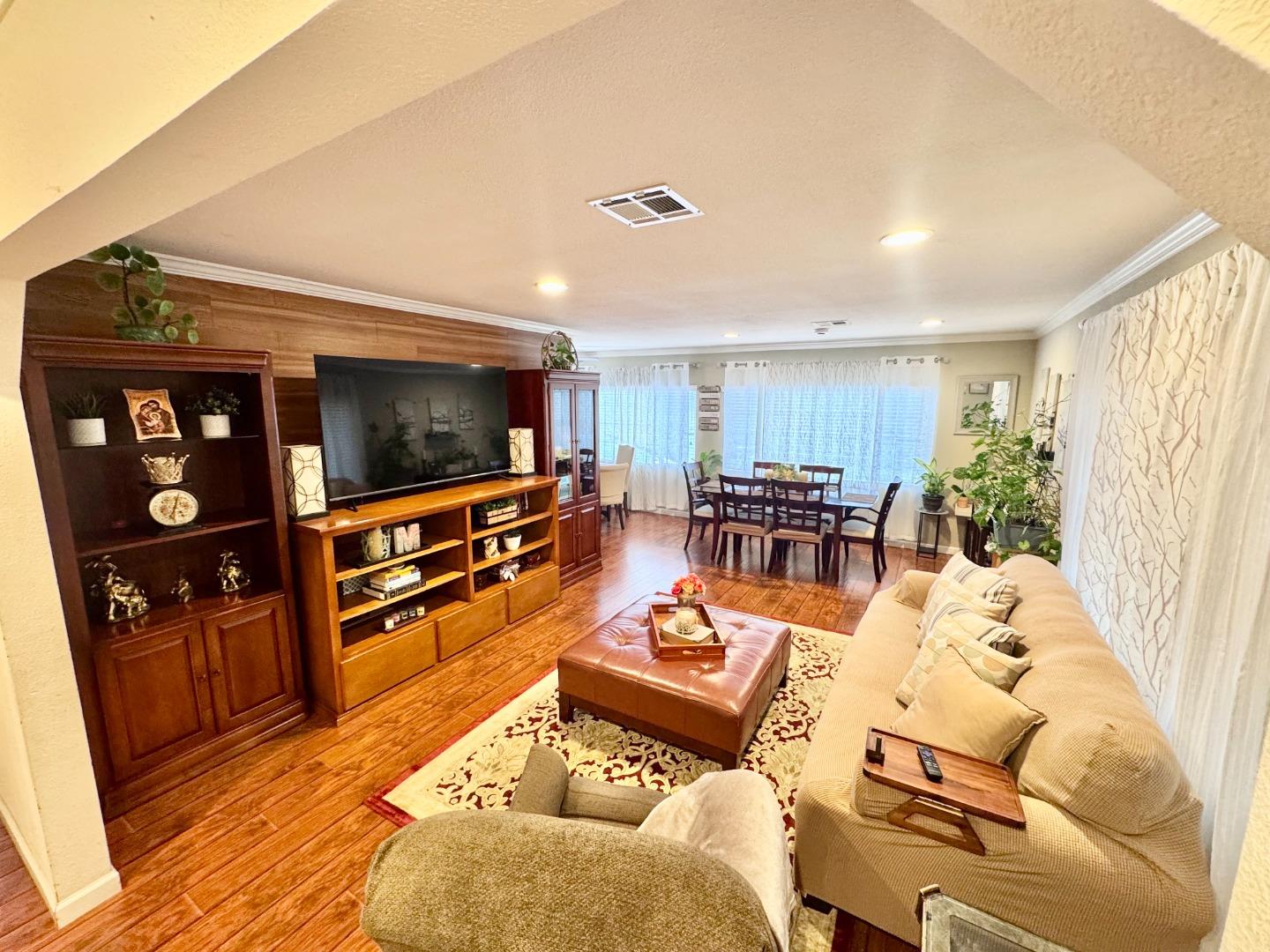 2151 Oakland Road, Unit 22 San Jose, CA 95131 - Photo 2 of 12 a living room with furniture a flat screen tv and wooden floor