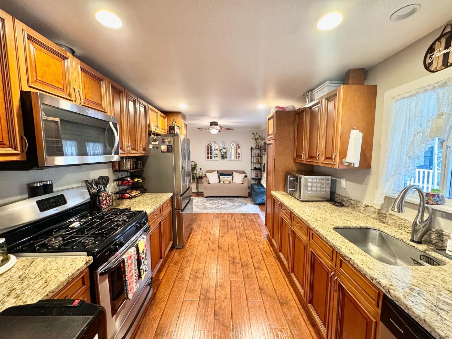 2151 Oakland Road, Unit 22 San Jose, CA 95131 - Photo 4 of 12 a kitchen with stainless steel appliances granite countertop a sink stove and refrigerator