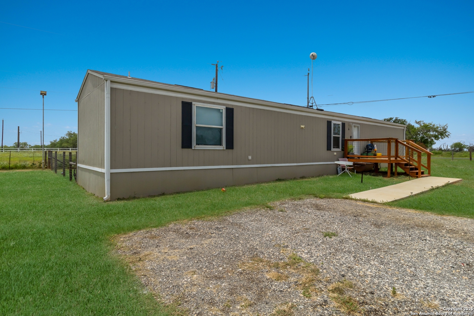 7380 Pittman Road Adkins, TX 78101 - Photo 2 of 16 a front view of a house with a yard