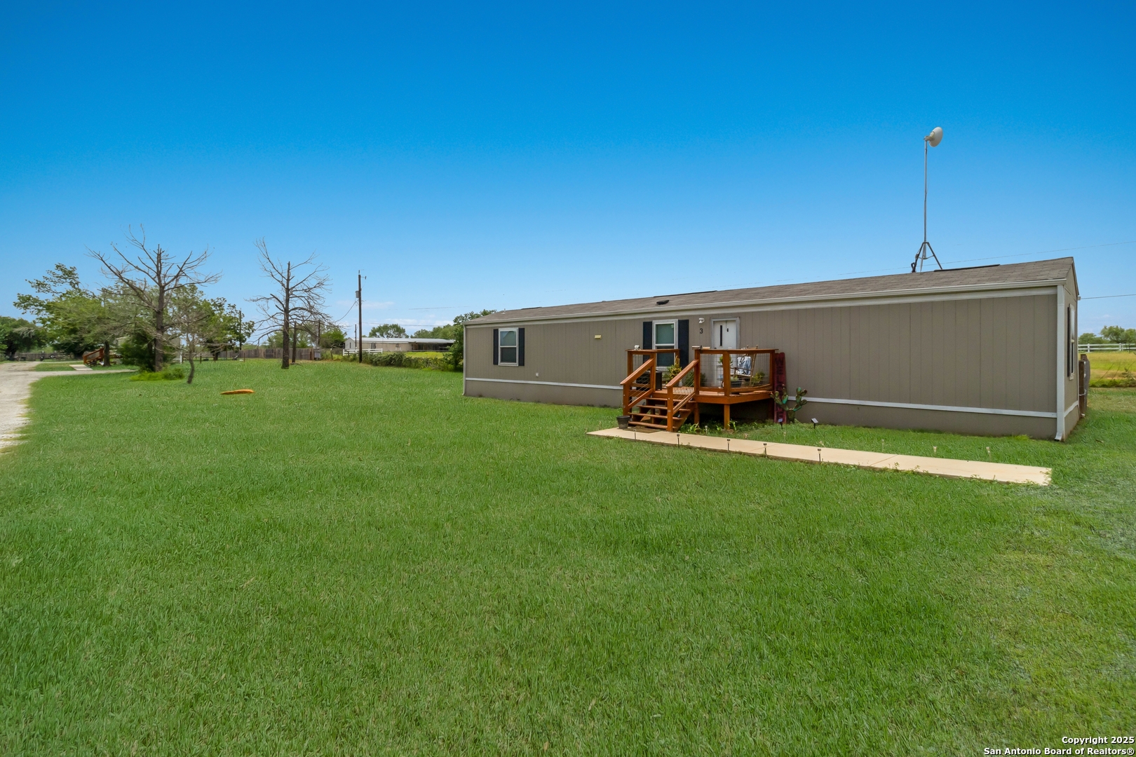 7380 Pittman Road Adkins, TX 78101 - Photo 5 of 16 a backyard of a house with table and chairs