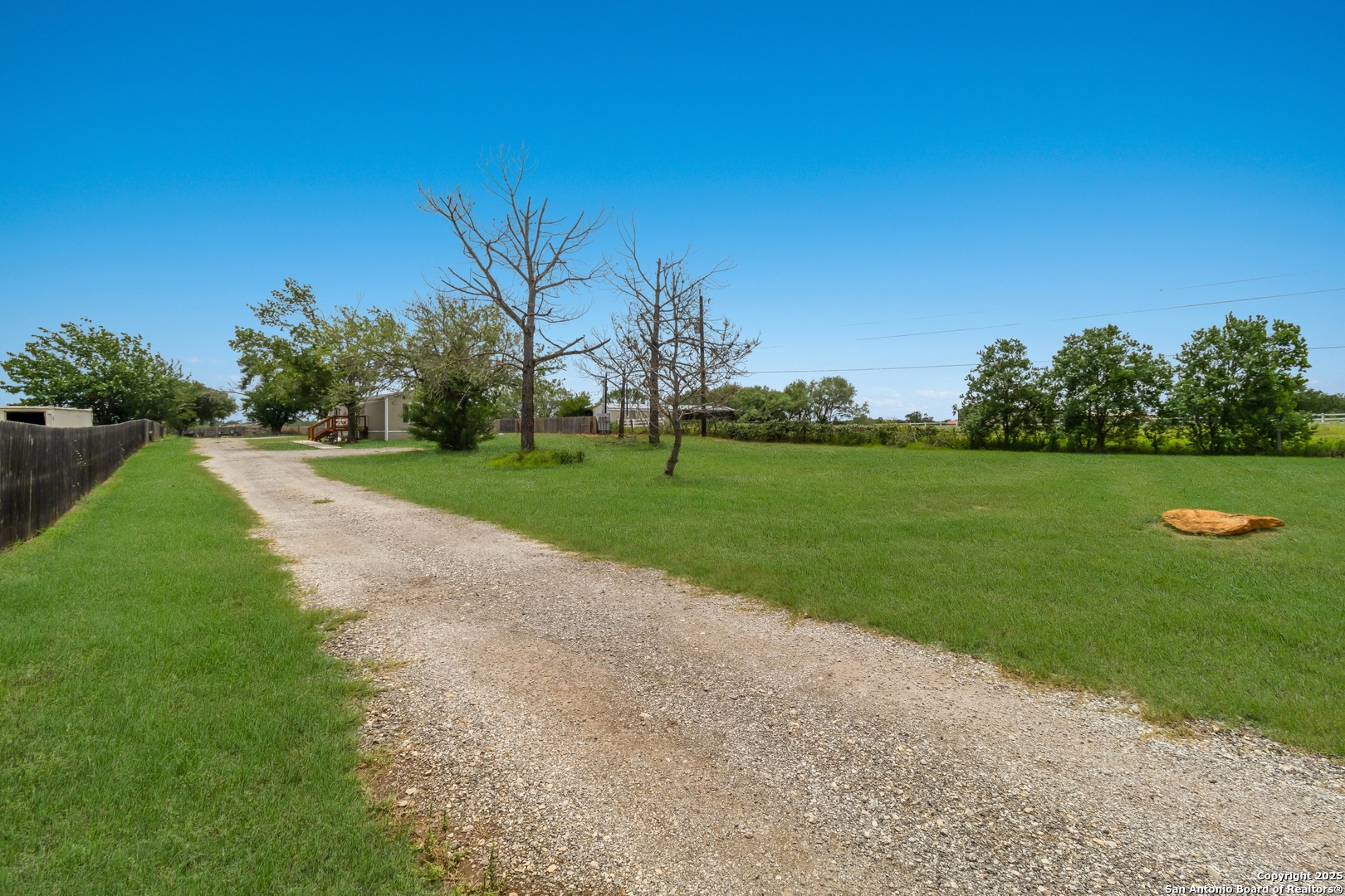 7380 Pittman Road Adkins, TX 78101 - Photo 7 of 16 a view of a golf course with a garden