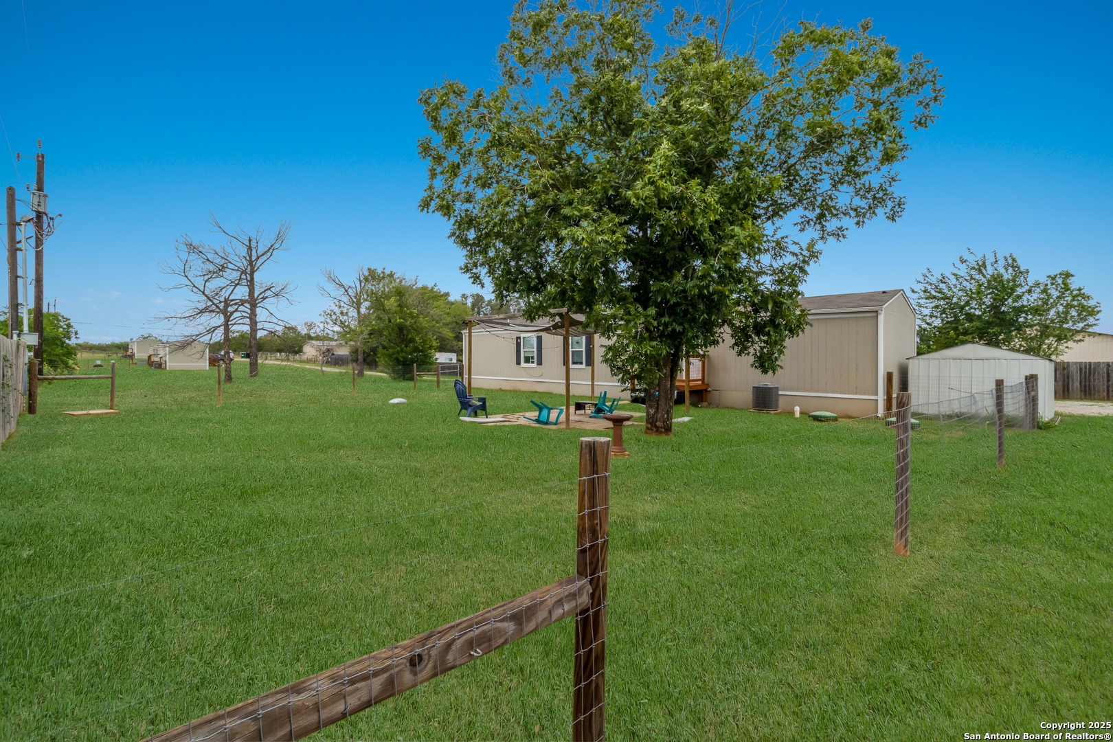 7380 Pittman Road Adkins, TX 78101 - Photo 9 of 16 a view of a house with backyard and a tree