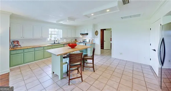 a dining room with furniture a flat screen tv and wooden floor