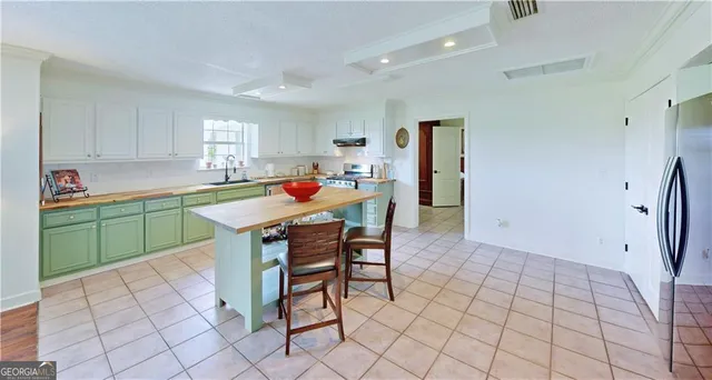 a dining room with furniture a flat screen tv and wooden floor
