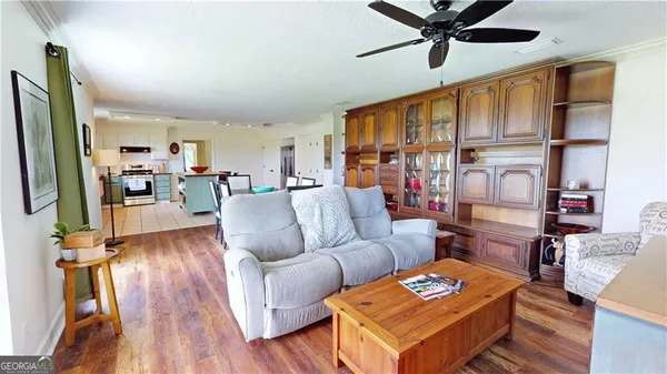 a spacious bedroom with a bed a couch and a flat screen tv