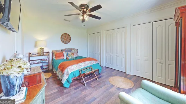 a view of a tennis ground with large trees