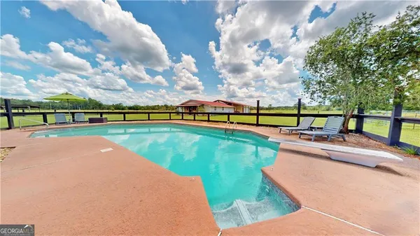 an aerial view of swimming pool with a yard