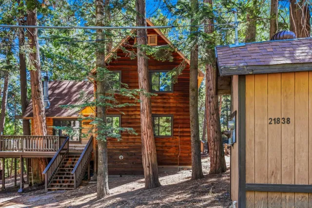 a view of house with backyard and trees