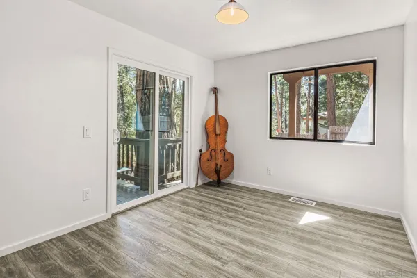 a view of a room with wooden floor and a window