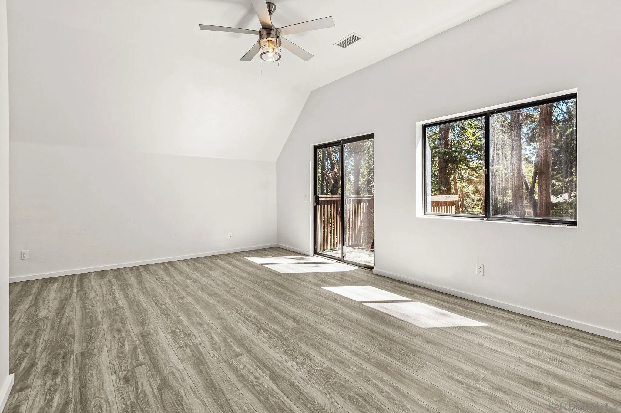 21838 Crestline Road Palomar Mountain, CA 92060 - Photo 8 of 26 a view of an empty room with a window and wooden floor