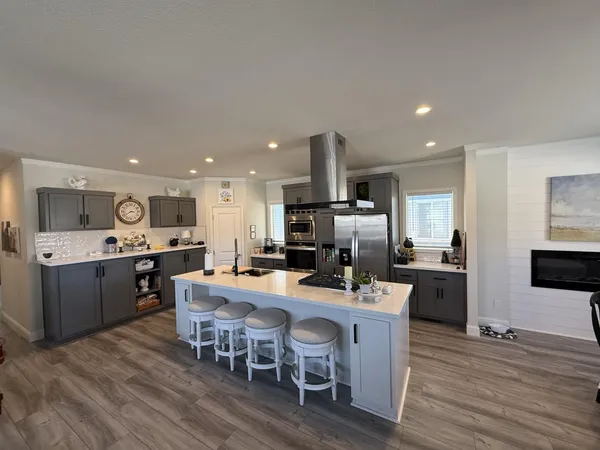 a large kitchen with a table and chairs