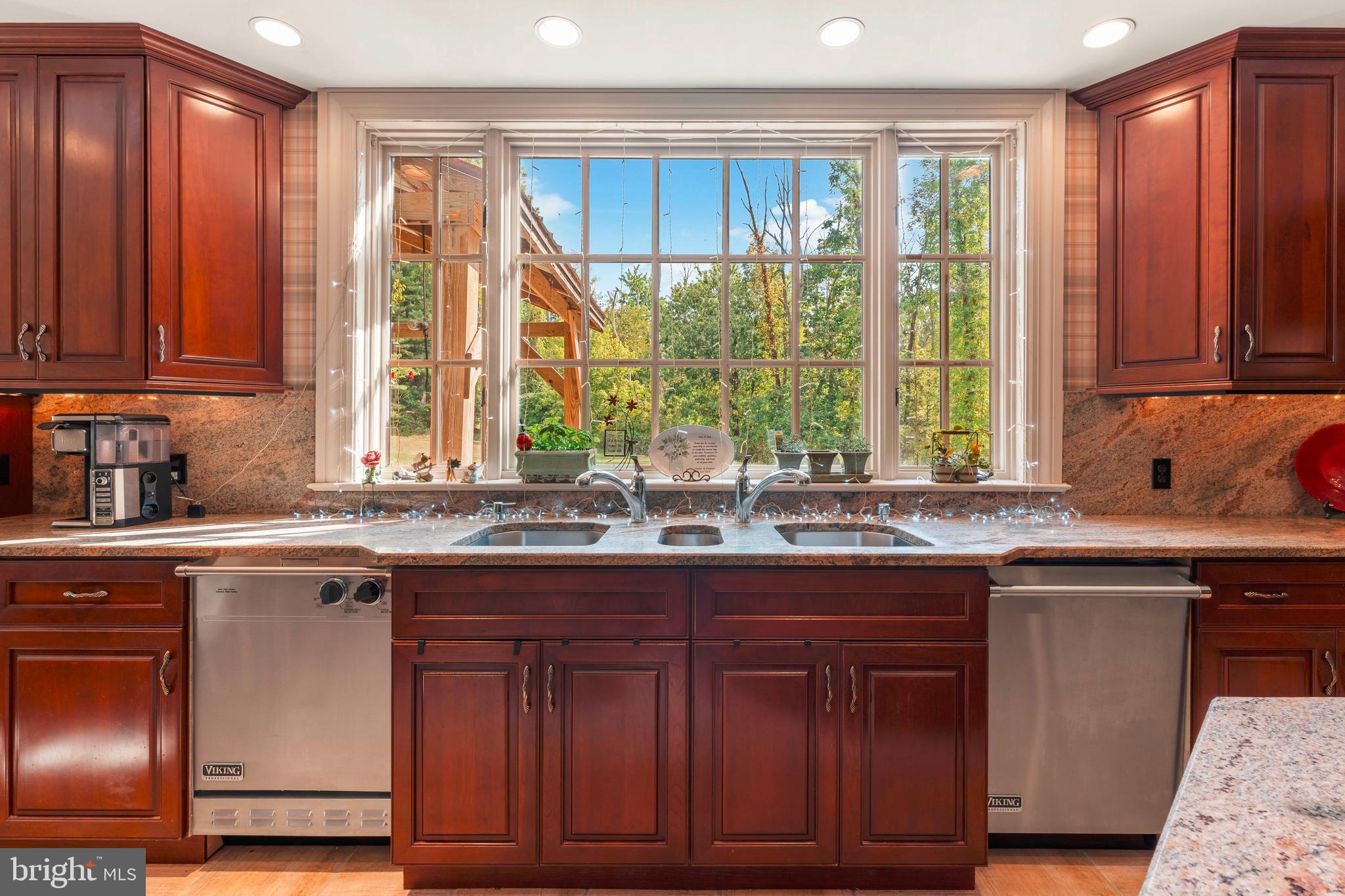 1390 Old Jacksonville Road Ivyland, PA 18974 - Photo 13 of 75 a kitchen with kitchen island granite countertop wooden cabinets a sink and a large window