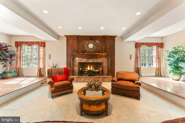 a living room with a bed furniture and a window