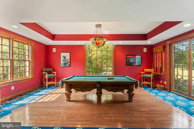 a living room with furniture a flat screen tv and a large window