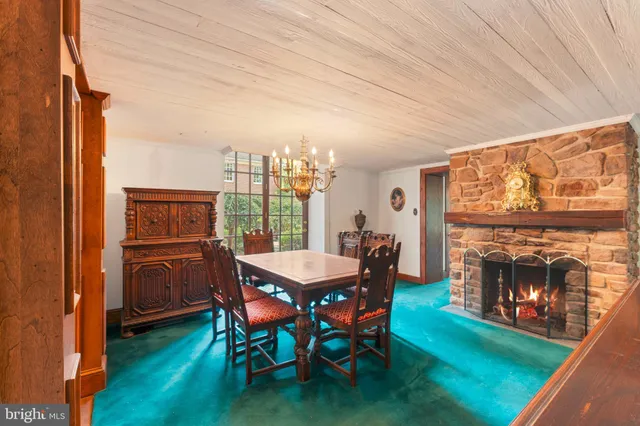 a kitchen with a sink a stove a microwave cabinets and dining table